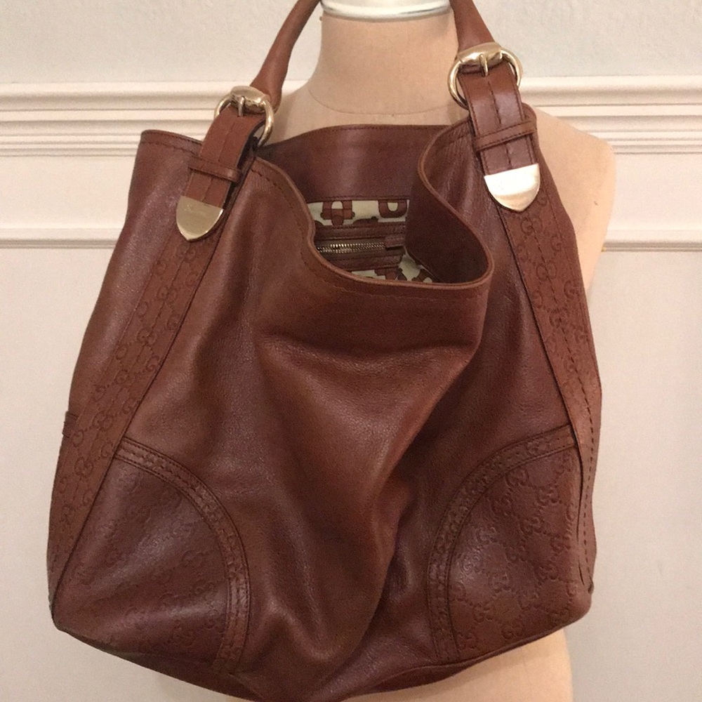 With Gucci tan leather monogram